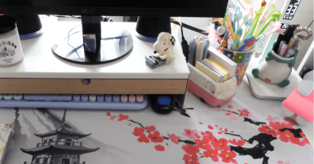A desk with various stationery items around. Lots of pastel colors.