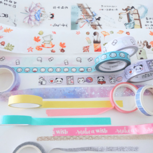 Pastel-colored unrolled rolls of washi tape.