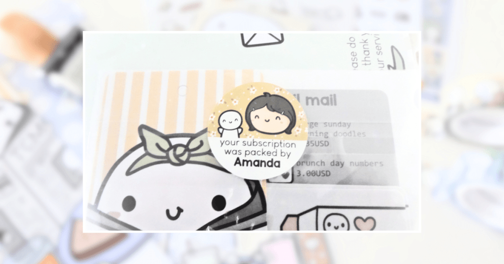 A close-up of the sticker on the cellophane envelope saying "Your subscription was packed by Amanda".