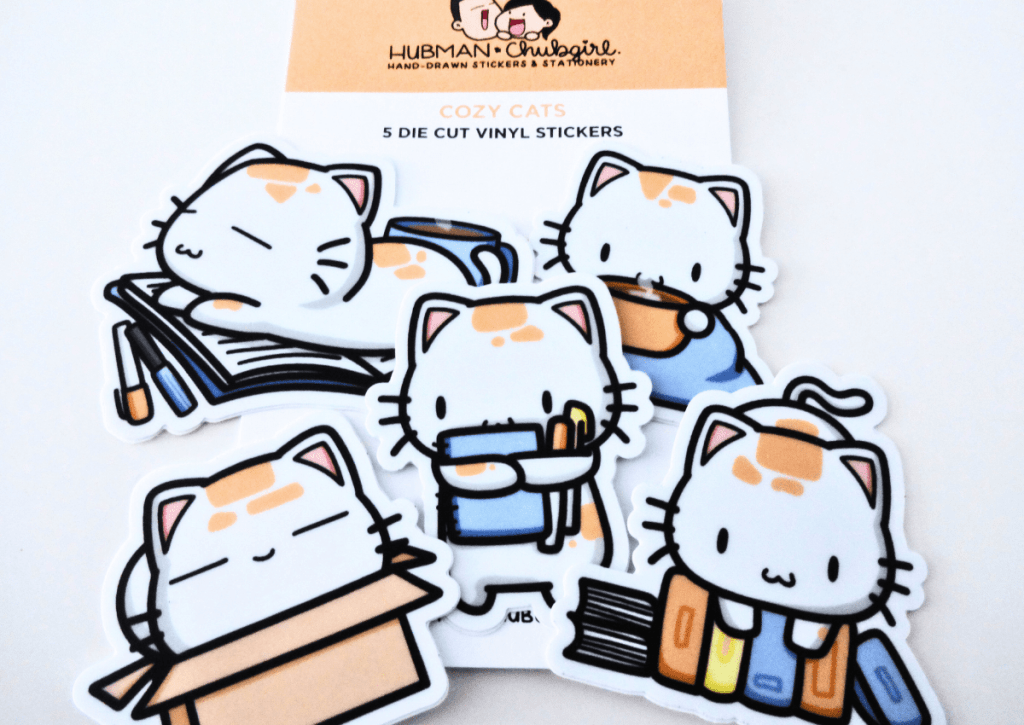Close-up of the five die-cut vinyl stickers included in the Cozy Cat box set.