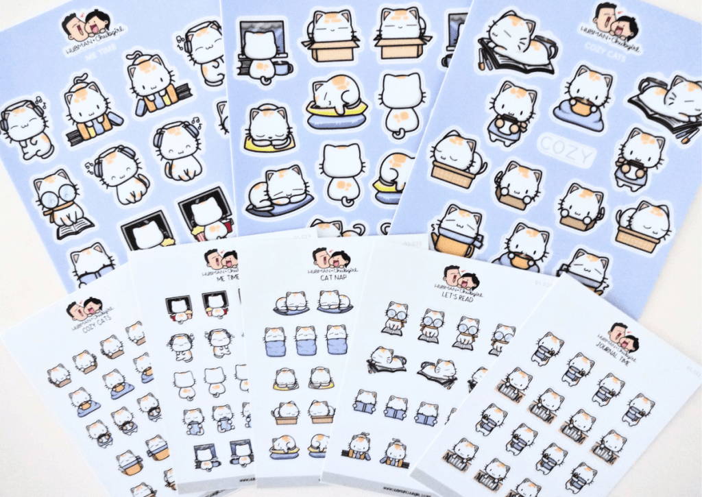 An arrangement of the eight sheets of stickers included in the Cozy Cat box set.