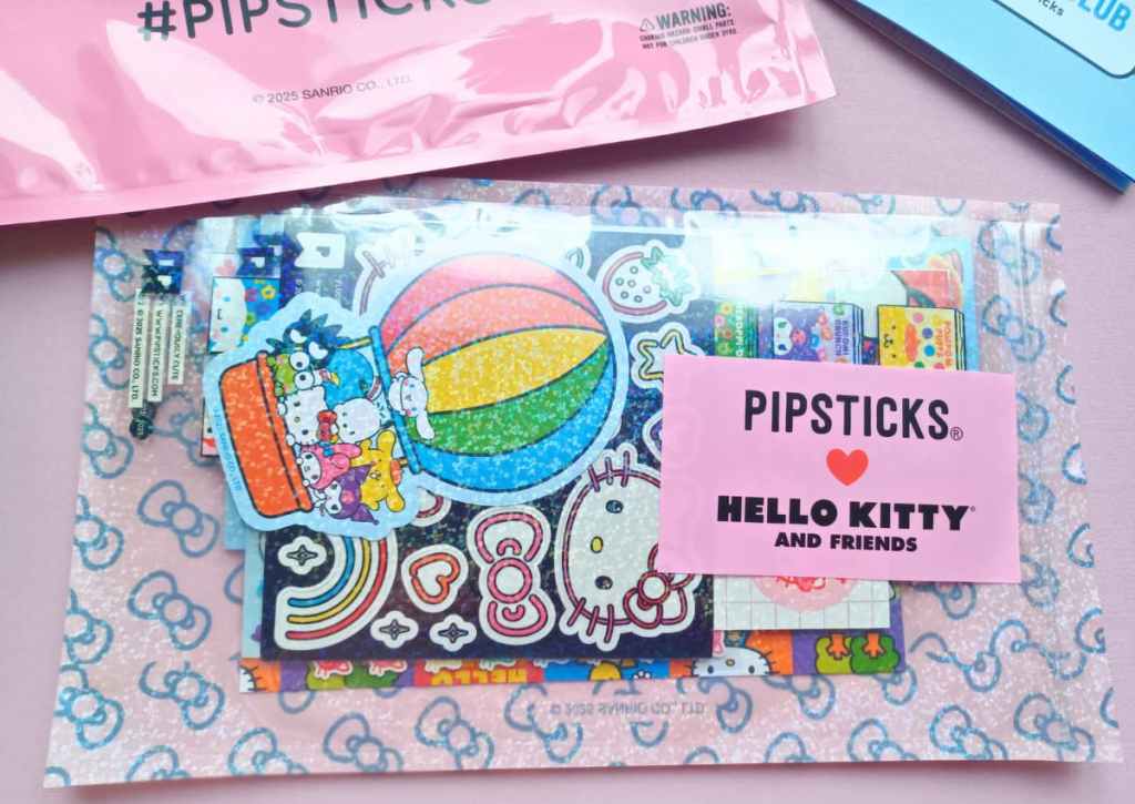A transparent pouch with many Sanrio sticker sheets inside.