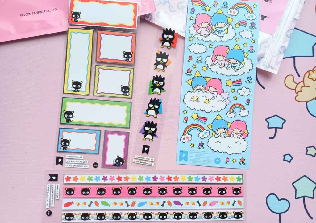 Flatlay of sticker sheets focused on Sanrio characters Chococat, Badtz-Marun and the Twin Stars Lala and Kiki