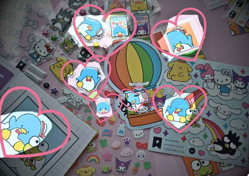 Flatlay of multiple sticker sheets with the character Tuxedosam highlighted