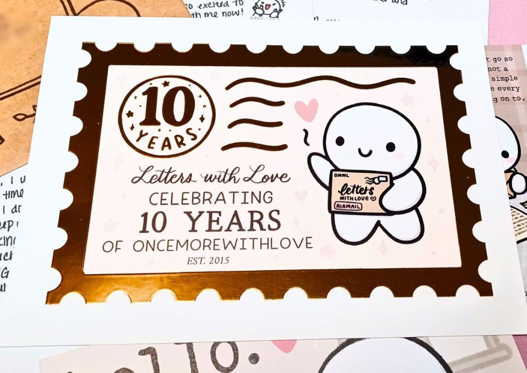 A gold embossed art print celebrating ten years of OnceMoreWithLove