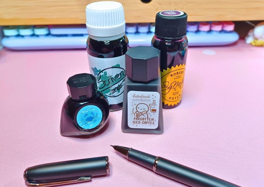 Fountain pen ink bottles of various shapes, sizes and colors.