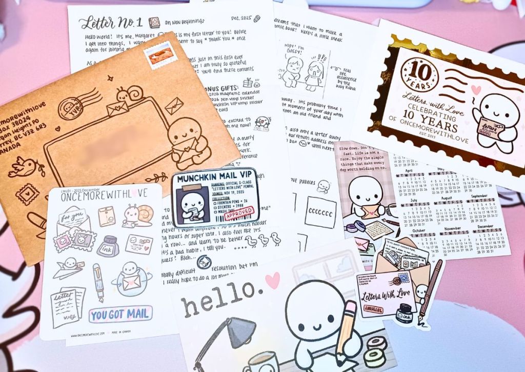 A brown envelope with a cute design, a letter titled "On new beginnings", and other stationery items such as a sticker sheet and a postcard about writing and sending mail.
