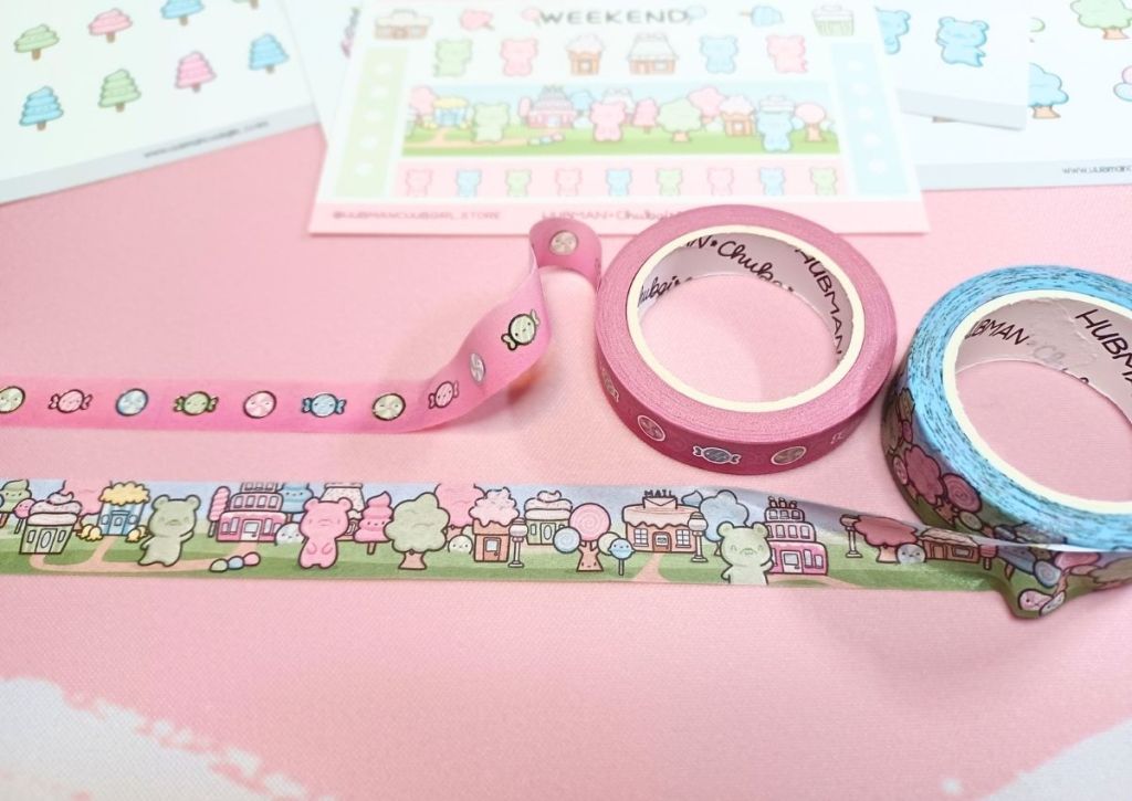 Two rolls of cute washi tapes unfurled to display the candies and gummy bears designs.
