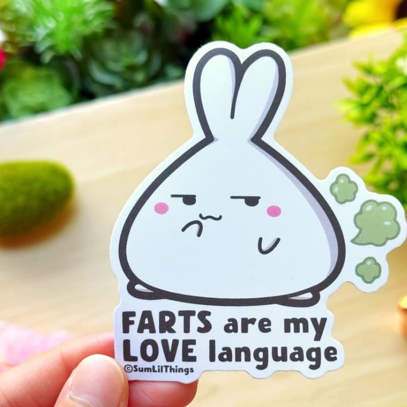 A hand drawn sticker of a bunny farting with the text "Farts are my love language."