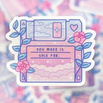 A dreamy-colored sticker of a diskette with roses and pastel skies and the words "You've made it this far."