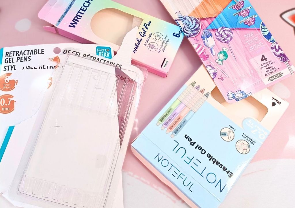 Four colorful packs of gel pens, opened with the pens gone.