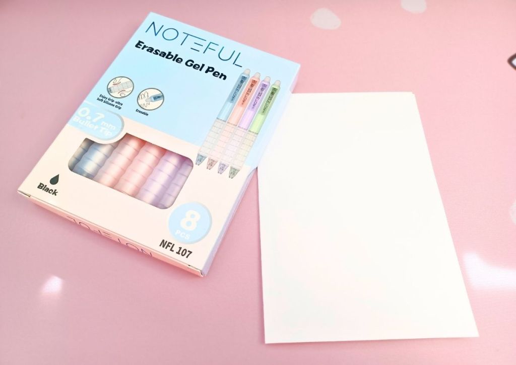 A pastel box containing eight pastel-colored pens.