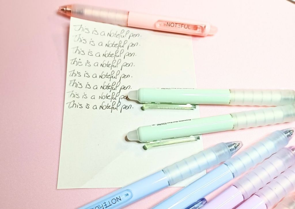 A page with a writing test repeated over and over, surrounded by the soft pastel Noteful pens.
