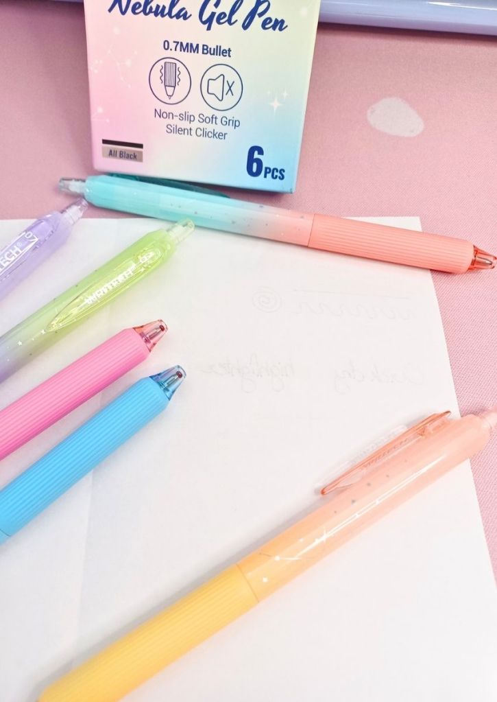 A white sheet surrounded by colorful pens and showing pale writing appearing through the paper.