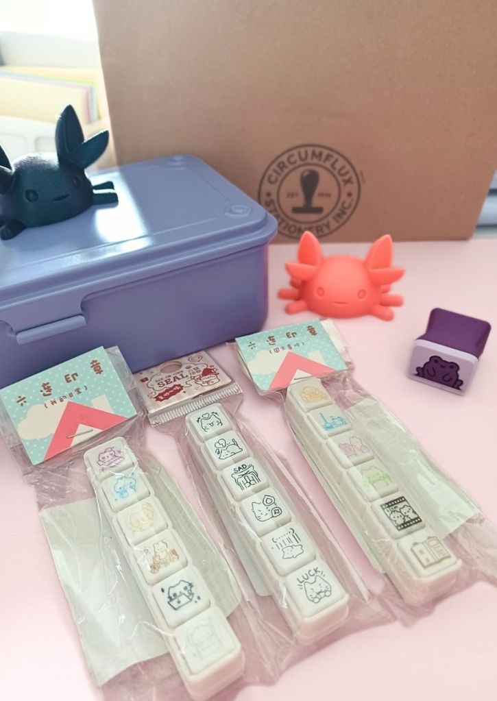 Two colorful pen-holder crabs, three fun button-punch stamps, a cute purple frog stamp, and a purple storage box.