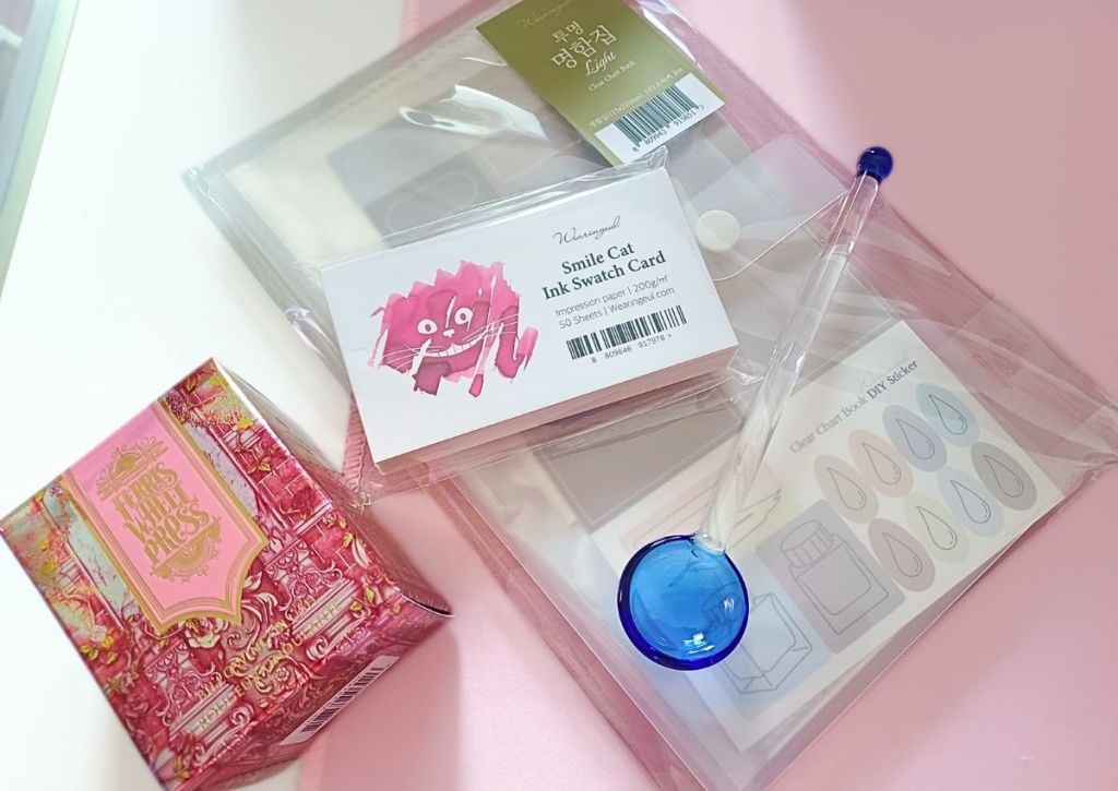 A variety of stationery items including ink swatch cards and a beautiful ink box from Ferriswheel Press.