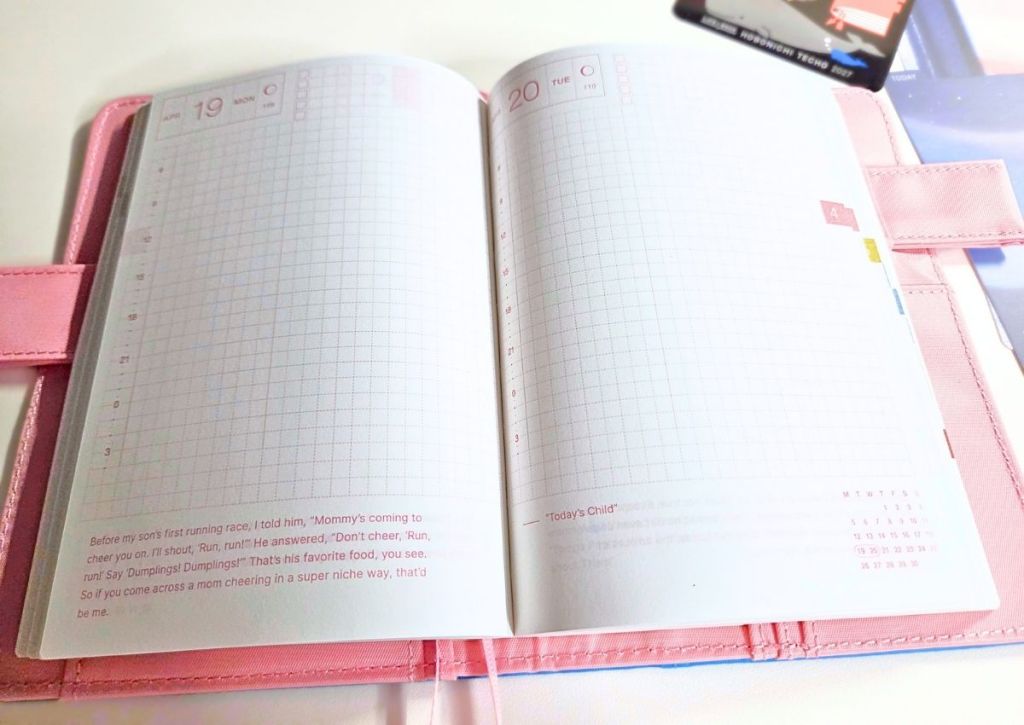 Open Hobonichi Techo planner in a pink cover, showing blank grid pages for April 19 and 20 with a printed quote at the bottom.