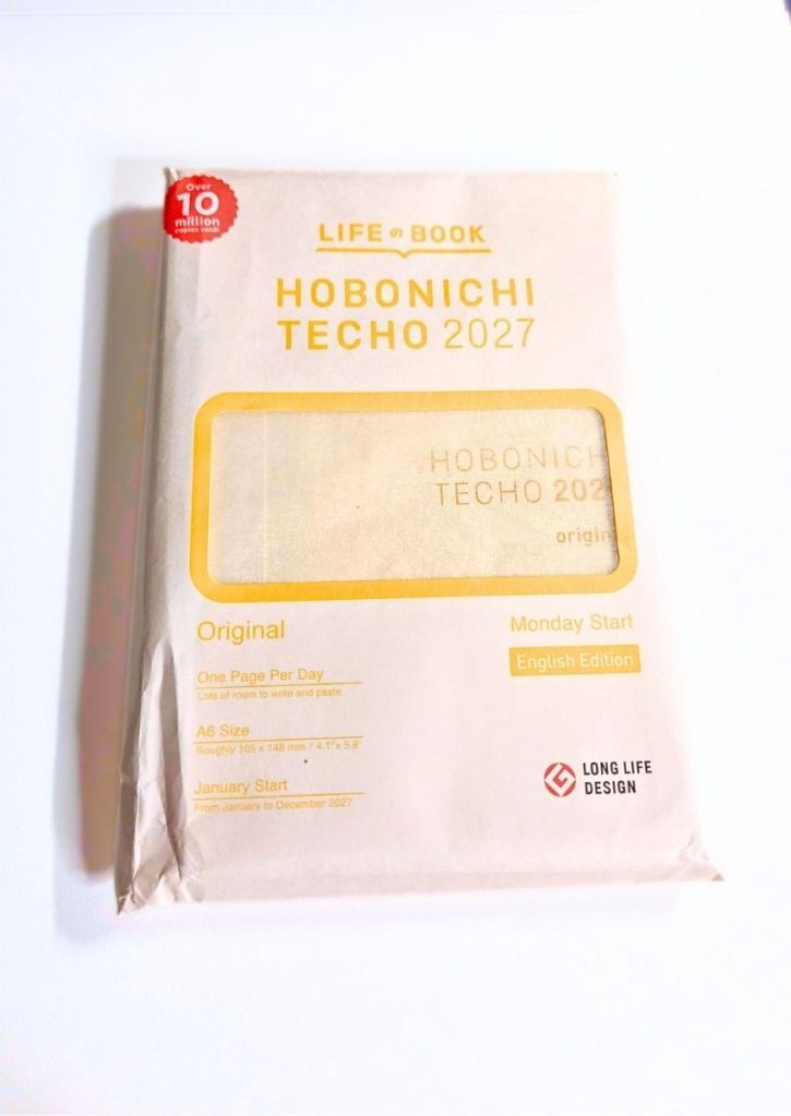 Packaging for a Hobonichi Techo 2027 Original planner, showing it is an English edition, A6 size, with a Monday start.