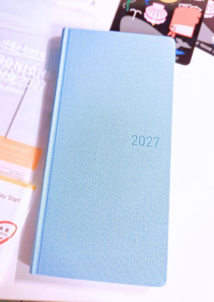 A light blue planner with 2027 embossed on the front cover.
